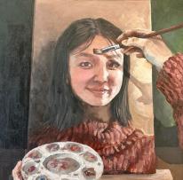 painting of a girl on an easel, with artist palette in foreground. hand seen wearing matching sweater doing the painting.