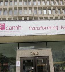 camh sign with camh logo that says &quot;transforming lives&quot;